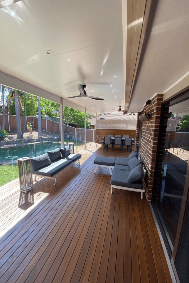 Hardwood deck with outdoor lounge under an insulated pergola