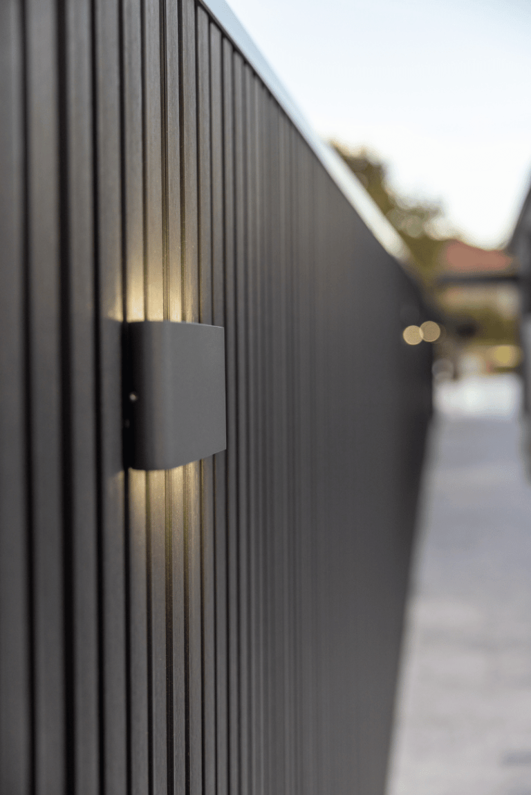 Dark vertical cladding with an outdoor wall light