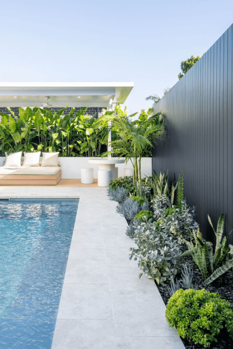 Pool with paved surrounds and landscaped garden